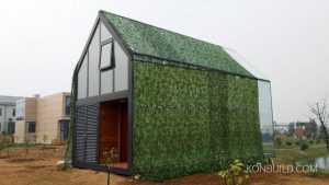 A simply shaped resort building, with mirrors on the exterior surfaces.