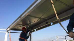 A Chinese construction worker, works on a aluminium prefab home.