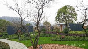 A garden of several "Moonbox" resort buildings. A calm setting, constructed quickly for this project.