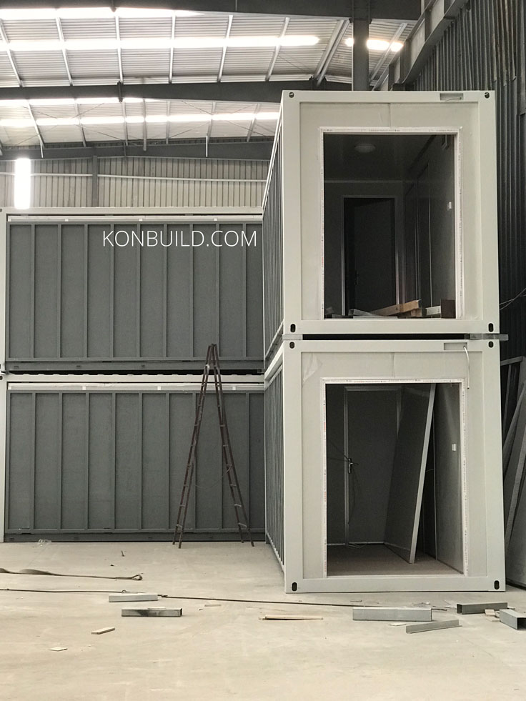 Multiple staked container homes during the stage of them being built.